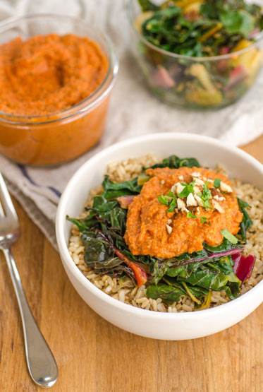 Tangy and a tad sweet, smoky, spicy, and so, so good: Brown Rice Bowl with Chard and Nutty Tomato Romesco 'Happy' Sauce is a quick one-bowl  winner of a dinner