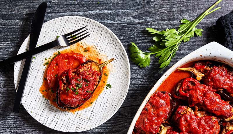 With a hint of fall in the air, it's time to tuck into cheesy stuffed eggplants with tomato and onion
	
	