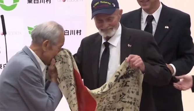 A Marine took a flag from a fallen Japanese soldier. Decades later, it's back with the soldier's family
	