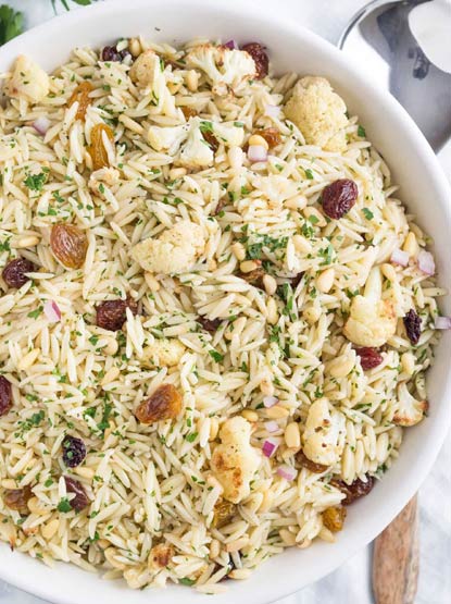With caramelized cauliflower for flavor, toasted pine nuts for subtle crunch, and raisins and sultanas for a perfect hint of sweet --- a salad even the most picky husband will delight in
