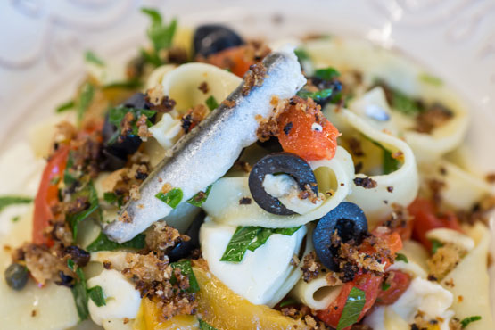 Classic Mediterranean flavors and colors fly in Pappardelle With Mozzarella, Grilled Peppers and Olives
  